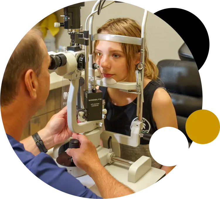 Girl getting an eye exam with Dr. Olney.