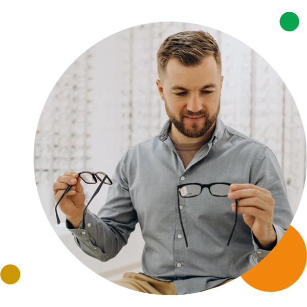 Man looking at glasses at Olney EyeCare.