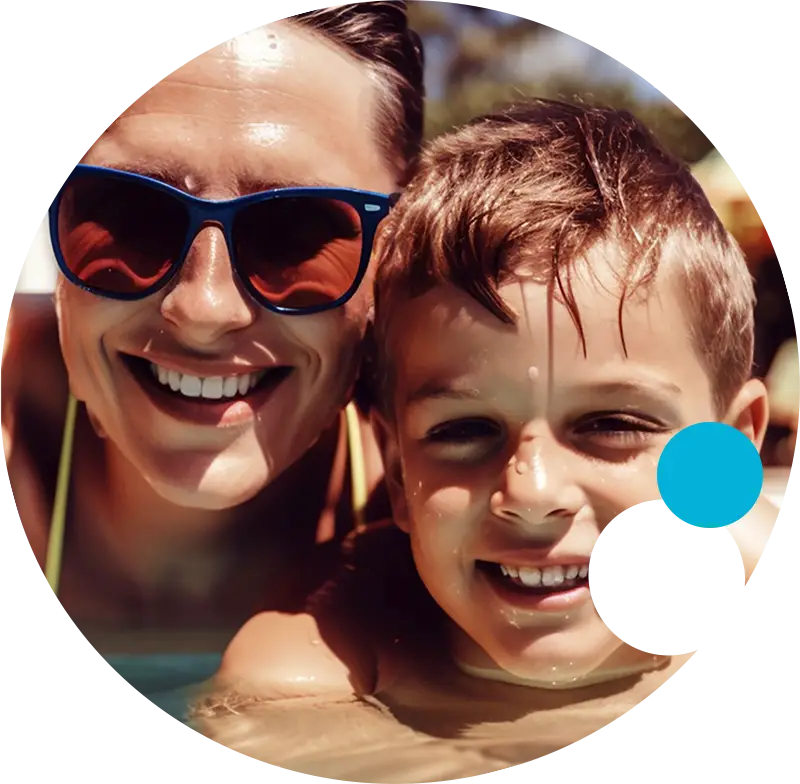 Mom with sunglasses with her son in a pool.